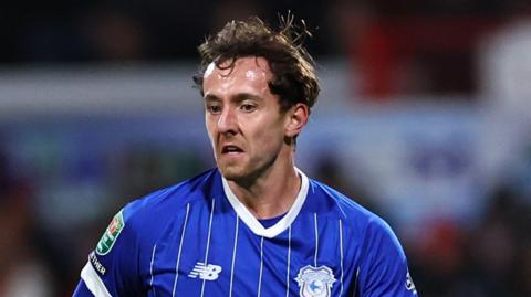 Ryan Wintle in a blue Cardiff City jersey.