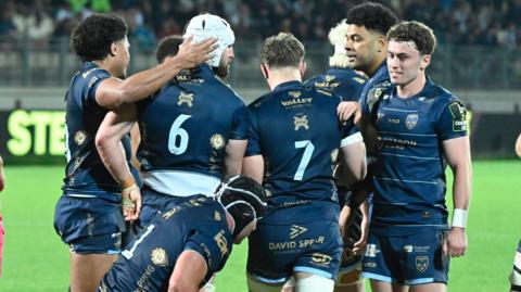 Dragons players celebrate a try against Zebre