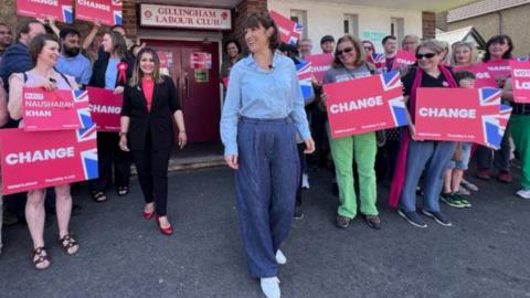 Rachel Reeves, Shadow Chancellor, surrrounded by Labour supporters with placards, outside Gillingham Labour Club