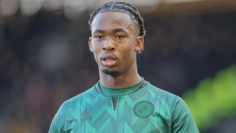 Zak Sturge, wearing Millwall's green away kit