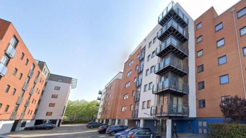 Sirocco apartments on the right. The building is has V-shaped balconies on two corners.