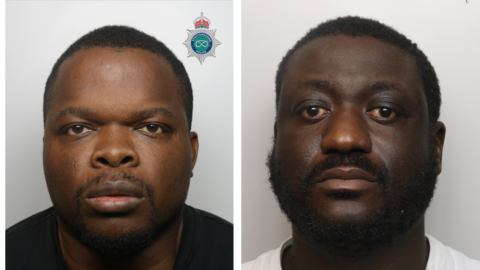 Two men with dark hair and dark-coloured beards are pictured with neutral expressions in front of a neutral-coloured background. Peter Nwankwo is pictured in a black t-shirt, while Lamin Jallow is wearing a white t-shirt.