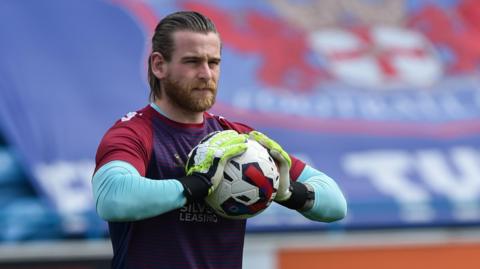 Lee Burge warming up for Northampton Town