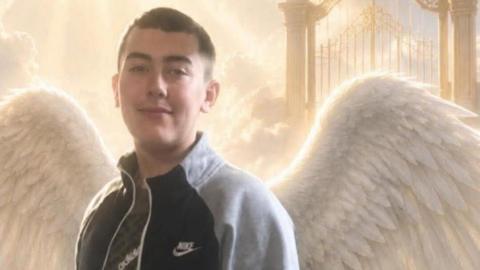 A photo of Joshua Oxley with angel wings. He has short dark hair and dark eyes.