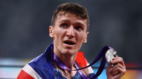 Jake Wightman holding his medal