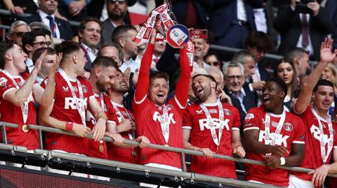 Charlton Athletic players celebrate with the League One play-off final trophy