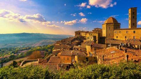 Volterra town skyline in Tuscany at sunset.