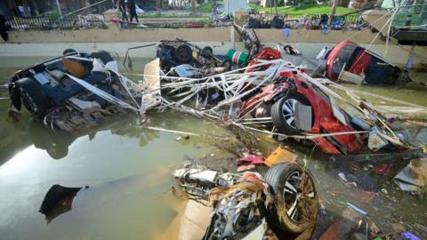 Wreckage of cars remain submerged in the water after flash floods in Valencia.