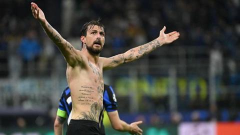 Francesco Acerbi celebrates with his shirt off, showing a number of tattoos on his body