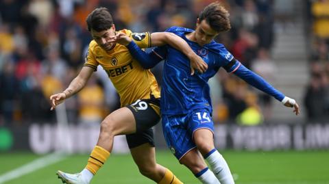 Wolves' Rodrigo Gomes battles for the ball with Chelsea's Joao Felix