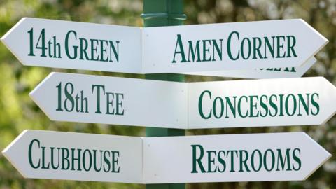 A sign at Augusta National Golf Club showing directions to Amen Corner, the 18th tee, concessions, the clubhouse and restrooms