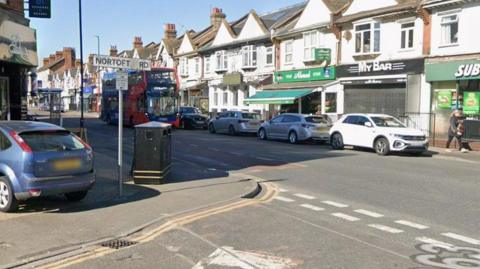 Street with shops underneath terrace.