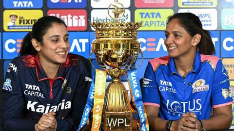 Smriti Mandhana of RCB and Harmanpreet Kaur of Mumbai Indians with the WPL trophy