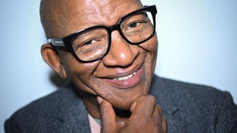 A close-up photo of South African composer Lebo M, who is wearing glasses.