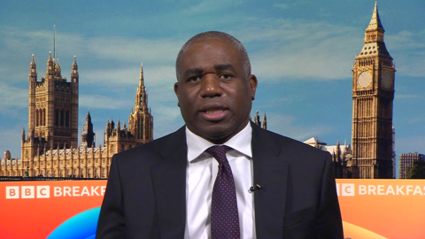 David Lammy, wearing a white shirt and dark tie