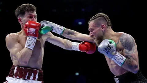 Liam Davies is punched by Francesco Grandelli