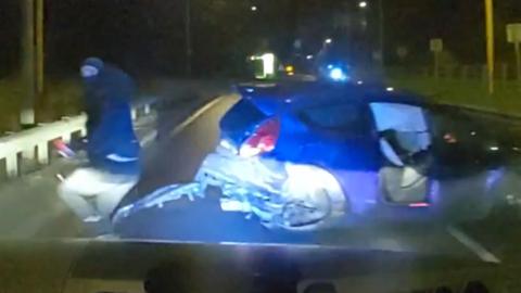 Man runs from crashed car.