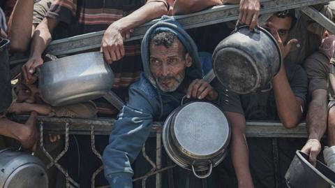 People wait to receive aid food in Gaza City. Photo: 30 July 2025