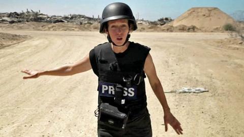 Lucy Williamson in Gaza wearing a helmet and protective equipment
