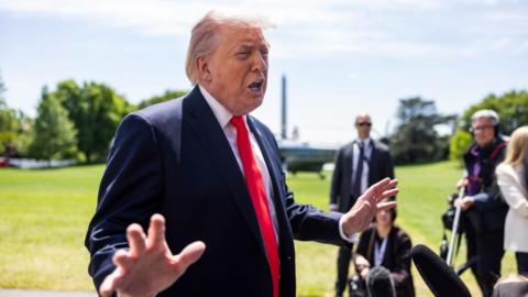 US President Donald Trump speaks to reporters as he departs the White House for Florida