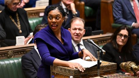 Kemi Badenoch looks away from camera as she speaks at PMQs in the House of Commons