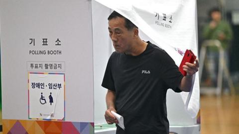A man votes in South Korea