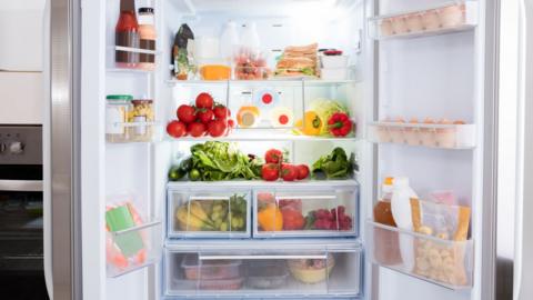 An open fridge filled with various foods and beverages
