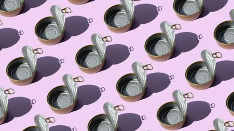 Pattern of repeated small tin cans on a purple background