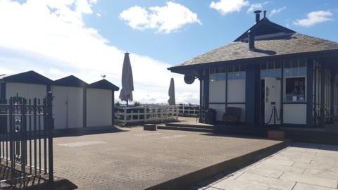 The patio and a side of a former tram shelter which is now a cafe