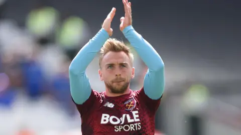 Jarrod Bowen clapping West Ham fans while warming up for game with Portsmouth
