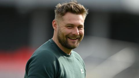 Luke Wright smiles towards the camera