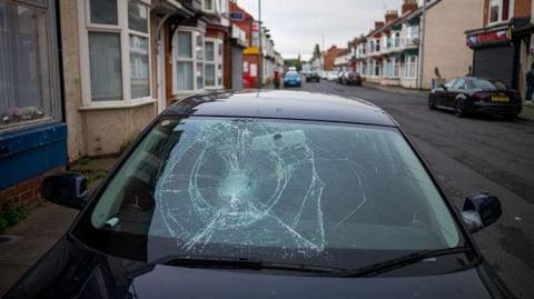 A black car window smashed.