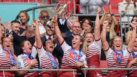 Wigan Warriors lift the Women's Challenge Cup trophy after their win against St Helens
