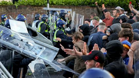 Protesters clash with police officers during a demonstration following the conviction of Vikrum Digwa for the murder of student Henry Nowak