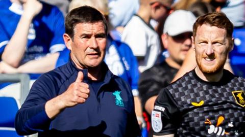 Mansfield boss Nigel Clough gives a thumbs-up