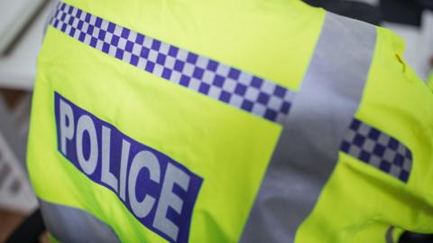 A police officer with a high-visibility jacket