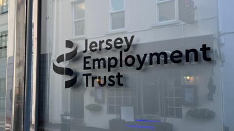 The Jersey Employment Trust sign is emblazoned on a window in black text.