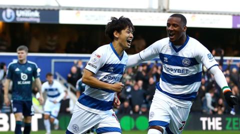 Koki Saito of Queens Park Rangers (left) celebrates scoring his team's first goal against Leicester