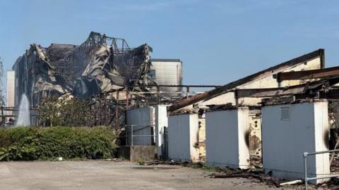A fire-damaged building that has collapsed and exposed the structure of the building. 