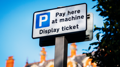 A pay and display car park sign.