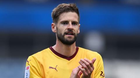 Northampton Town captain Jon Guthrie applauding