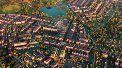 An aerial view of an artist's impression of the new garden town. There are rows of houses, a lake and trees throughout as well as low rise blocks of flats.