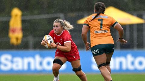  Alex Callender of Wales runs the ball