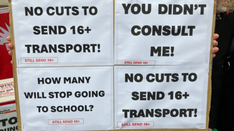 Protest posters are pictured against the loss of funding for SEND transport in Leicester