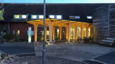 The main entrance to St Richard's Hospice at dusk 