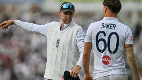 England's Joe Root speaks with Sonny Baker