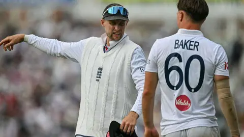 England's Joe Root speaks with Sonny Baker
