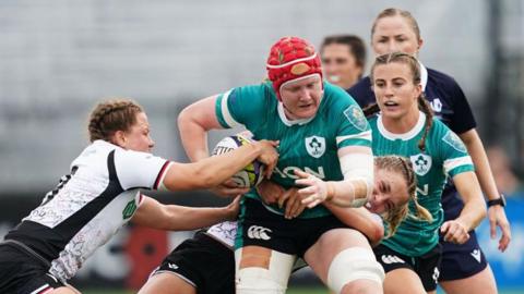 Ireland's Aoife Wafer is tackled by Canada's Caroline Crossley and Justine Pelletier