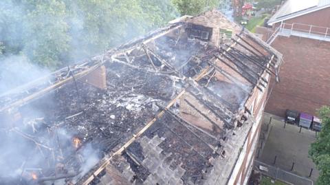 Burnt out roof of Dalston Lane flats