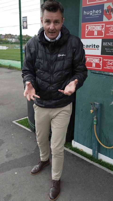 Andy stood in front of a football pitch